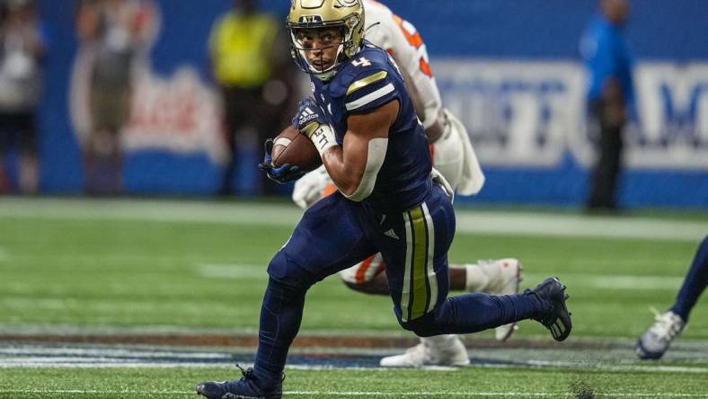 Sep 5, 2022; Atlanta, Georgia, USA; Georgia Tech Yellow Jackets running back Dontae Smith (4) runs against the Clemson Tigers during the first half at Mercedes-Benz Stadium. Mandatory Credit: Dale Zanine-USA TODAY Sports