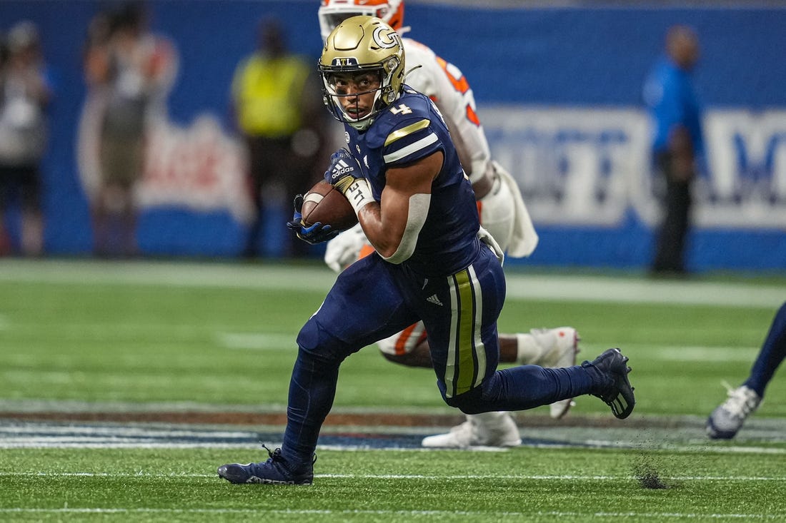 Sep 5, 2022; Atlanta, Georgia, USA; Georgia Tech Yellow Jackets running back Dontae Smith (4) runs against the Clemson Tigers during the first half at Mercedes-Benz Stadium. Mandatory Credit: Dale Zanine-USA TODAY Sports