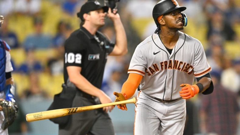 Sep 5, 2022; Los Angeles, California, USA;  San Francisco Giants center fielder Lewis Brinson (29) hits his second home run of the game, a solo shot in the ninth inning, against the Los Angeles Dodgers at Dodger Stadium. Mandatory Credit: Jayne Kamin-Oncea-USA TODAY Sports