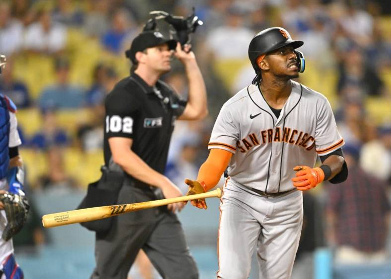 Sep 5, 2022; Los Angeles, California, USA;  San Francisco Giants center fielder Lewis Brinson (29) hits his second home run of the game, a solo shot in the ninth inning, against the Los Angeles Dodgers at Dodger Stadium. Mandatory Credit: Jayne Kamin-Oncea-USA TODAY Sports