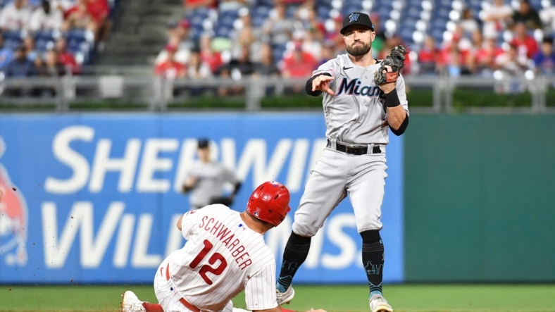 Sep 6, 2022; Philadelphia, Pennsylvania, USA; Philadelphia Phillies left fielder Kyle Schwarber (12) is forced out at second base by Miami Marlins third baseman Jon Berti (5) during the third inning at Citizens Bank Park. Mandatory Credit: Eric Hartline-USA TODAY Sports