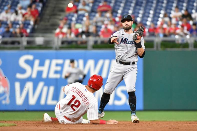 Sep 6, 2022; Philadelphia, Pennsylvania, USA; Philadelphia Phillies left fielder Kyle Schwarber (12) is forced out at second base by Miami Marlins third baseman Jon Berti (5) during the third inning at Citizens Bank Park. Mandatory Credit: Eric Hartline-USA TODAY Sports
