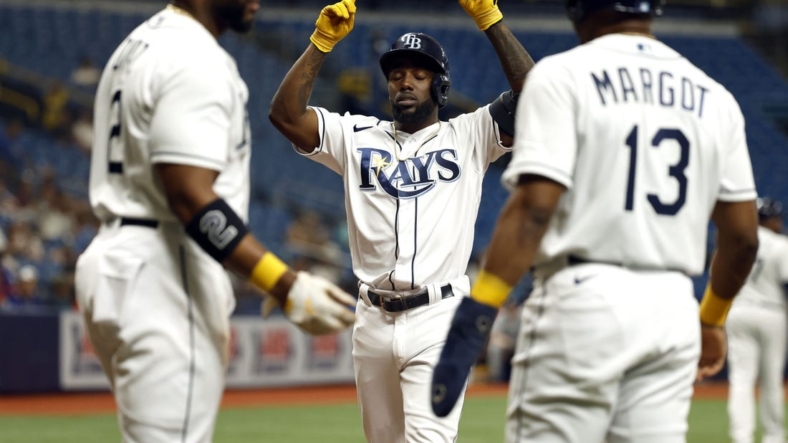 Sep 6, 2022; St. Petersburg, Florida, USA;Tampa Bay Rays left fielder Randy Arozarena (56) is congratulated by  third baseman Yandy Diaz (2) and right fielder Manuel Margot (13) after he hit a three-run home run against the Boston Red Sox during the first inning at Tropicana Field. Mandatory Credit: Kim Klement-USA TODAY Sports