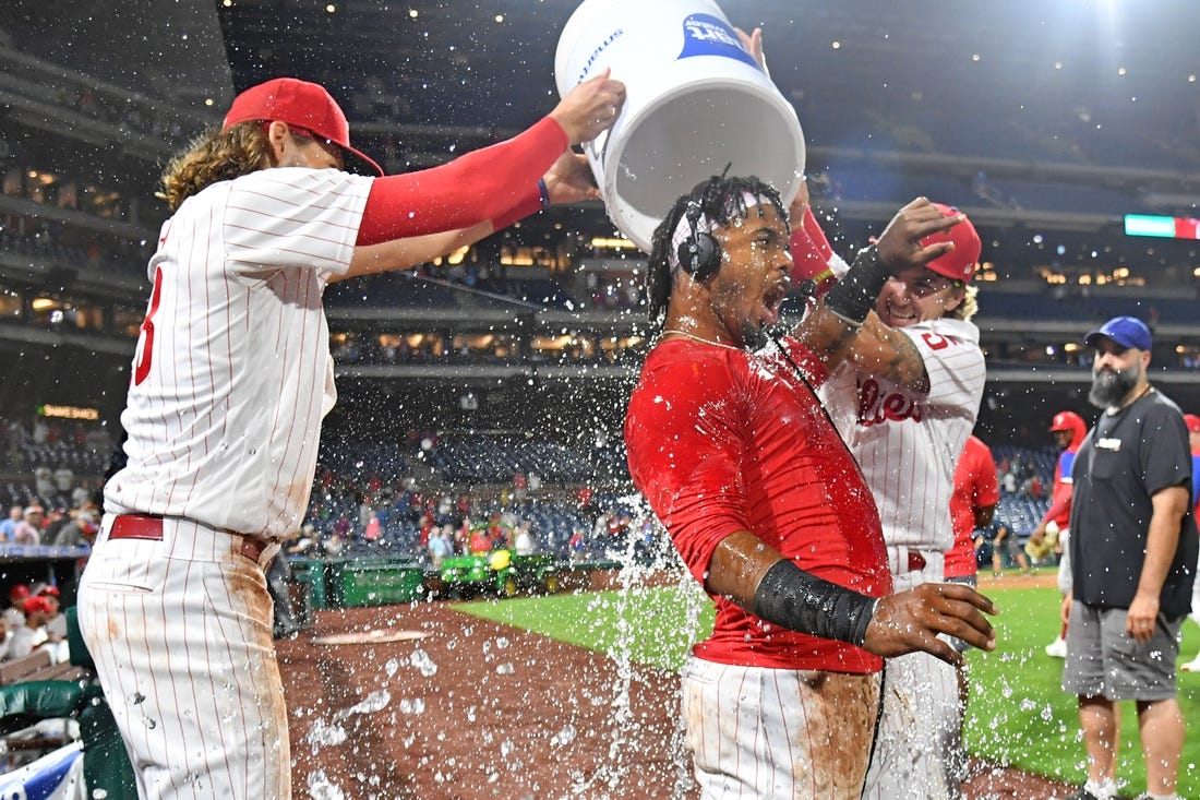 Sep 6, 2022; Philadelphia, Pennsylvania, USA;  Philadelphia Phillies second baseman Jean Segura (2) has water dumped on by third baseman Alec Bohm (28) and shortstop Bryson Stott (5)  after hitting a walk-off RBU single during the ninth inning against the Miami Marlins at Citizens Bank Park. Mandatory Credit: Eric Hartline-USA TODAY Sports