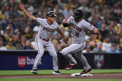 Sep 6, 2022; San Diego, California, USA; Arizona Diamondbacks catcher Carson Kelly (18) is waved home by third base coach Tony Perezchica (left) on a double hit by shortstop Sergio Alcantara (not pictured) during the fourth inning against the San Diego Padres at Petco Park. Mandatory Credit: Orlando Ramirez-USA TODAY Sports