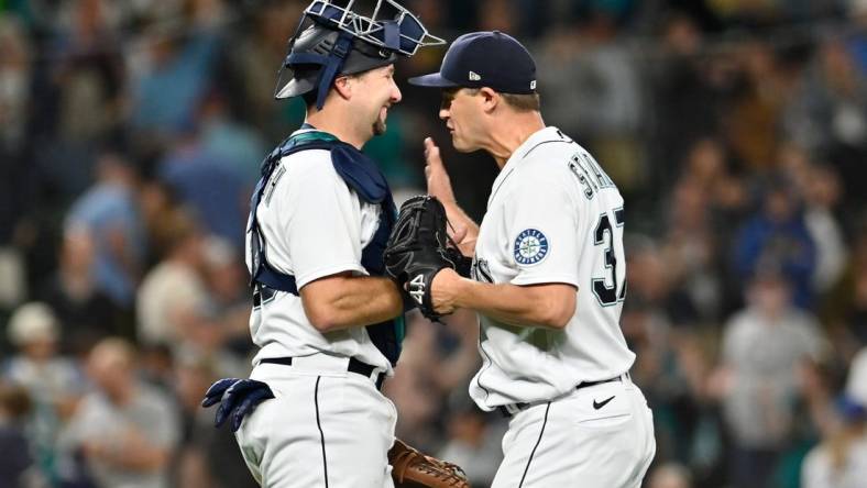 Sep 6, 2022; Seattle, Washington, USA; Seattle Mariners catcher Cal Raleigh (29) and Seattle Mariners relief pitcher Paul Sewald (37) celebrate defeating the Chicago White Sox at T-Mobile Park. Seattle defeated Chicago 3-0. Mandatory Credit: Steven Bisig-USA TODAY Sports