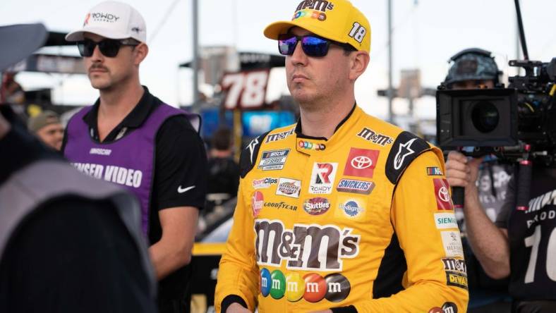 Sep 4, 2022; Darlington, South Carolina, USA; Kyle Busch, driver of the (18) M&M's Toyota, arrives for driver introductions prior to the COOK OUT Southern 500 at Darlington Raceway. Mandatory Credit: David Yeazell-USA TODAY Sports