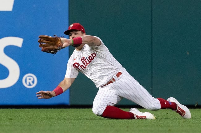 Sep 7, 2022; Philadelphia, Pennsylvania, USA; Philadelphia Phillies left fielder Kyle Schwarber (12) makes a sliding catch for an out during the second inning against the Miami Marlins at Citizens Bank Park. Mandatory Credit: Bill Streicher-USA TODAY Sports