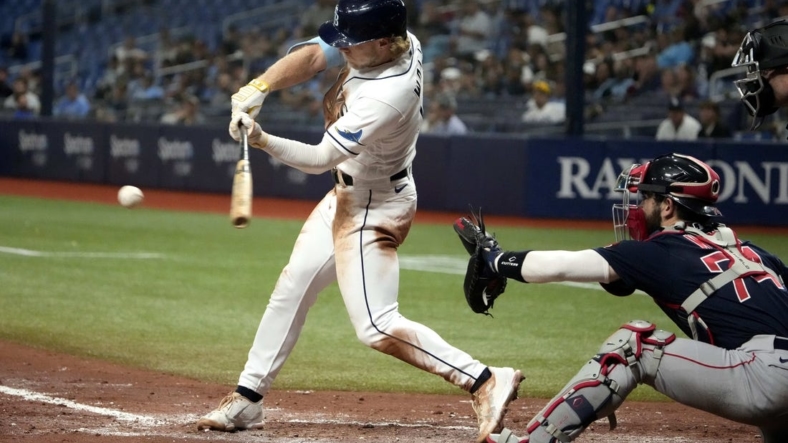Sep 7, 2022; St. Petersburg, Florida, USA; Tampa Bay Rays shortstop Taylor Walls (0) hits a single and drives catcher Francisco Mejia (21) in the fifth inning at Tropicana Field. Mandatory Credit: Dave Nelson-USA TODAY Sports