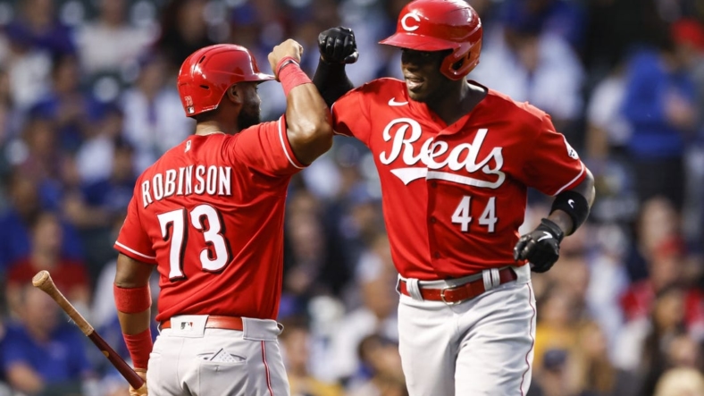 Sep 7, 2022; Chicago, Illinois, USA; Cincinnati Reds right fielder Aristides Aquino (44) celebrates with catcher Chuckie Robinson (73) after hitting a solo home run against the Chicago Cubs during the third inning at Wrigley Field. Mandatory Credit: Kamil Krzaczynski-USA TODAY Sports