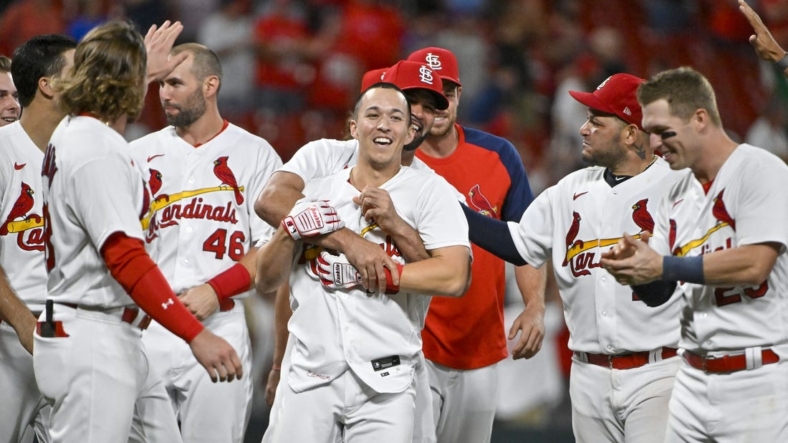 Sep 7, 2022; St. Louis, Missouri, USA;  St. Louis Cardinals shortstop Tommy Edman (19) celebrates with Albert Pujols (5)  and teammates after hitting a walk-off two run double against the Washington Nationals during the ninth inning at Busch Stadium. Mandatory Credit: Jeff Curry-USA TODAY Sports