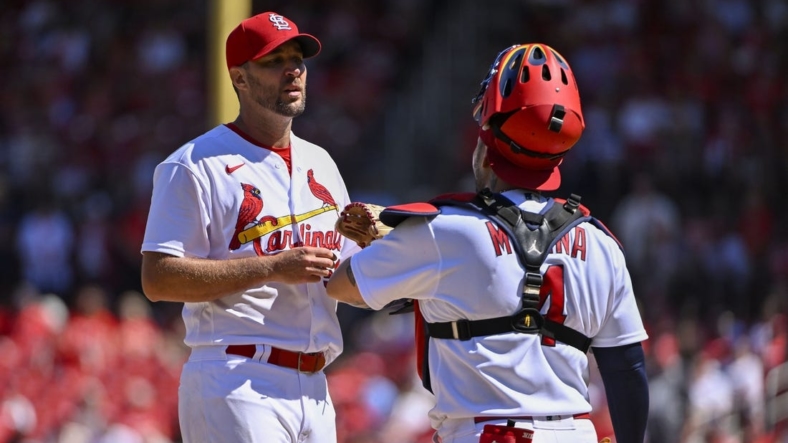 Sep 8, 2022; St. Louis, Missouri, USA;  St. Louis Cardinals starting pitcher Adam Wainwright (50) talks with catcher Yadier Molina (4) during the fifth inning against the Washington Nationals at Busch Stadium. Mandatory Credit: Jeff Curry-USA TODAY Sports