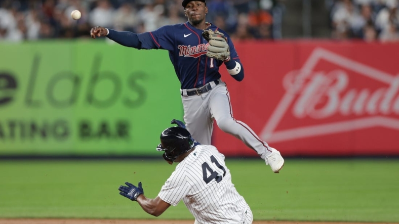Sep 8, 2022; Bronx, New York, USA; Minnesota Twins left fielder Nick Gordon (1) throws to first base to complete a double play as New York Yankees designated hitter Miguel Andujar (41) slides during the fourth inning at Yankee Stadium. Mandatory Credit: Vincent Carchietta-USA TODAY Sports