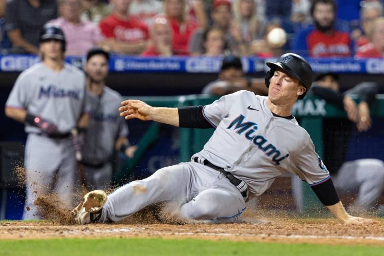 Sep 8, 2022; Philadelphia, Pennsylvania, USA; Miami Marlins third baseman Joey Wendle (18) slides into home plate for a run during the ninth inning against the Philadelphia Phillies at Citizens Bank Park. Mandatory Credit: Bill Streicher-USA TODAY Sports