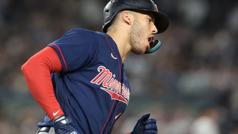 Sep 8, 2022; Bronx, New York, USA; Minnesota Twins shortstop Carlos Correa (4) reacts after hitting a two-run home run during the eighth inning against the New York Yankees at Yankee Stadium. Mandatory Credit: Vincent Carchietta-USA TODAY Sports