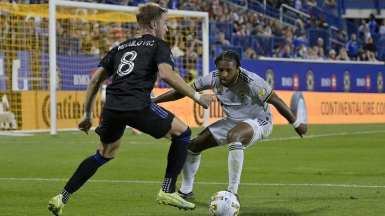 Sep 9, 2022; Montreal, Quebec, CAN; CF Montreal midfielder Djordje Mihailovic (8) plays the ball and Columbus Crew defender Steven Moreira (31) defends during the first half at Stade Saputo. Mandatory Credit: Eric Bolte-USA TODAY Sports