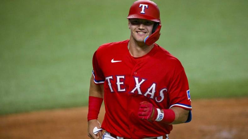 Sep 9, 2022; Arlington, Texas, USA; Texas Rangers third baseman Josh Jung (6) smiles as he comes home after he hits a home run in his first major league at bat during the third inning against the Toronto Blue Jays at the Globe Life Field. Mandatory Credit: Jerome Miron-USA TODAY Sports