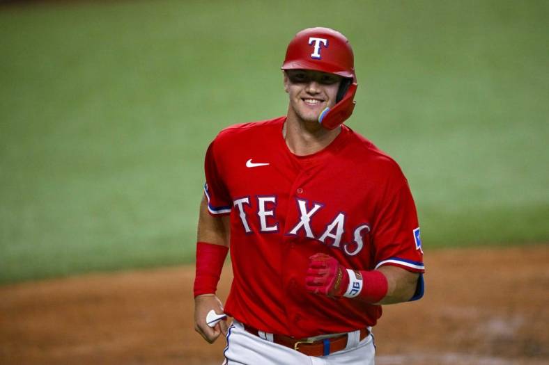 Sep 9, 2022; Arlington, Texas, USA; Texas Rangers third baseman Josh Jung (6) smiles as he comes home after he hits a home run in his first major league at bat during the third inning against the Toronto Blue Jays at the Globe Life Field. Mandatory Credit: Jerome Miron-USA TODAY Sports