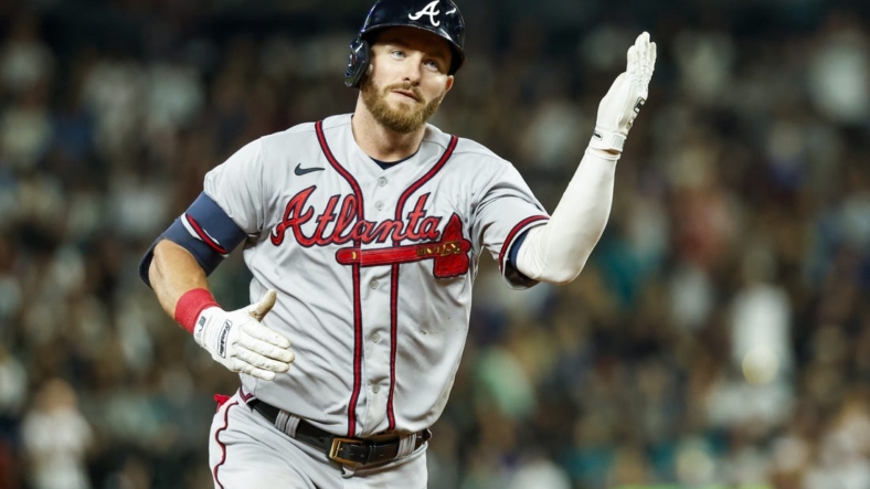 Sep 9, 2022; Seattle, Washington, USA; Atlanta Braves right fielder Robbie Grossman (15) does a tomahawk-chop after hitting a solo-home run against the Seattle Mariners during the sixth inning at T-Mobile Park. Mandatory Credit: Joe Nicholson-USA TODAY Sports