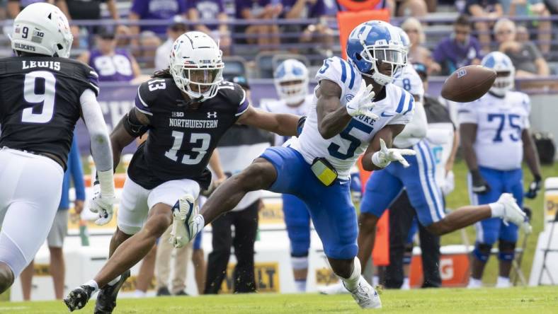 Sep 10, 2022; Evanston, Illinois, USA; Duke Blue Devils wide receiver Jalon Calhoun (5) receives a pass against Northwestern Wildcats defensive back Garnett Hollis Jr. (13) during the first quarter at Ryan Field. Mandatory Credit: Patrick Gorski-USA TODAY Sports