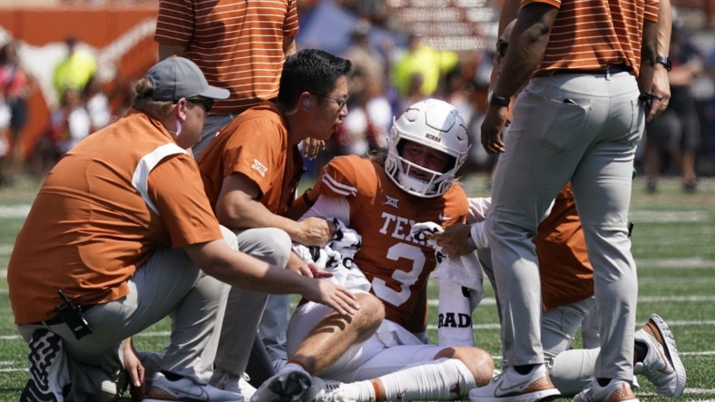 Sep 10, 2022; Austin, Texas, USA; Texas Longhorns quarterback Quinn Ewers (3) is attended to after getting hit while throwing a pass against the Alabama Crimson Tide during the first half at at Darrell K Royal-Texas Memorial Stadium. Mandatory Credit: Scott Wachter-USA TODAY Sports