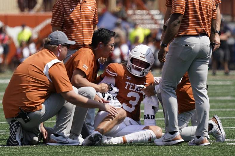 Sep 10, 2022; Austin, Texas, USA; Texas Longhorns quarterback Quinn Ewers (3) is attended to after getting hit while throwing a pass against the Alabama Crimson Tide during the first half at at Darrell K Royal-Texas Memorial Stadium. Mandatory Credit: Scott Wachter-USA TODAY Sports