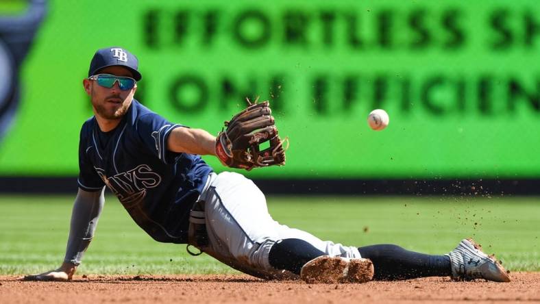 Sep 10, 2022; Bronx, New York, USA; Tampa Bay Rays second baseman Brandon Lowe (8) makes a diving catch and flips the ball to Tampa Bay Rays infielder Wander Franco (5) (not pictured) against the New York Yankees during the first inning at Yankee Stadium. Mandatory Credit: Dennis Schneidler-USA TODAY Sports