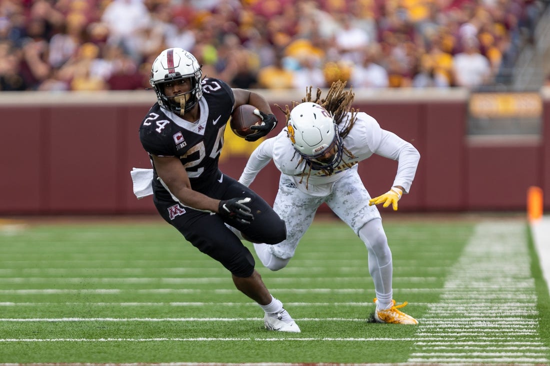 Sep 10, 2022; Minneapolis, Minnesota, USA; Minnesota Golden Gophers running back Mohamed Ibrahim (24) evades  by Western Illinois Leathernecks defensive back Corey Scott (24) in the second quarter at Huntington Bank Stadium. Mandatory Credit: Matt Blewett-USA TODAY Sports