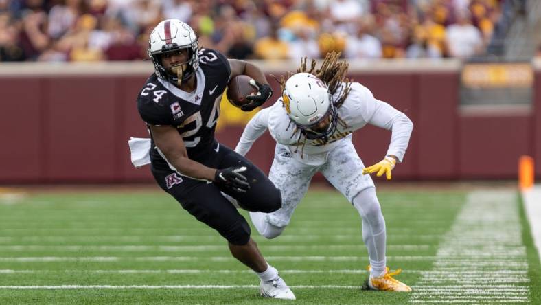 Sep 10, 2022; Minneapolis, Minnesota, USA; Minnesota Golden Gophers running back Mohamed Ibrahim (24) evades  by Western Illinois Leathernecks defensive back Corey Scott (24) in the second quarter at Huntington Bank Stadium. Mandatory Credit: Matt Blewett-USA TODAY Sports