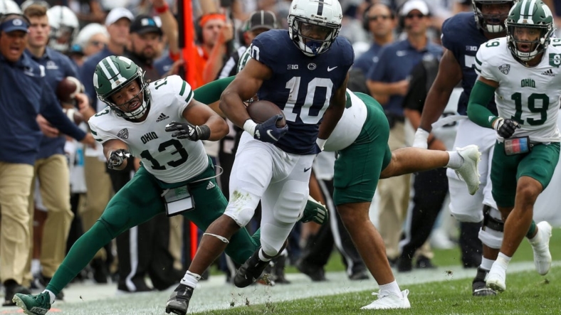Sep 10, 2022; University Park, Pennsylvania, USA; Penn State Nittany Lions running back Nicholas Singleton (10) avoids a tackle while running with the ball during the first quarter against the Ohio Bobcats at Beaver Stadium. Mandatory Credit: Matthew OHaren-USA TODAY Sports