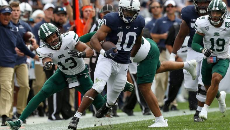 Sep 10, 2022; University Park, Pennsylvania, USA; Penn State Nittany Lions running back Nicholas Singleton (10) avoids a tackle while running with the ball during the first quarter against the Ohio Bobcats at Beaver Stadium. Mandatory Credit: Matthew OHaren-USA TODAY Sports