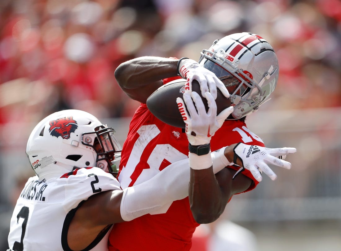 Sep 10, 2022; Columbus, Ohio, USA;  Ohio State Buckeyes wide receiver Marvin Harrison Jr. (18) makes the touchdown catch over Arkansas State Red Wolves cornerback Leon Jones (2) during the second half at Ohio Stadium. Mandatory Credit: Joseph Maiorana-USA TODAY Sports