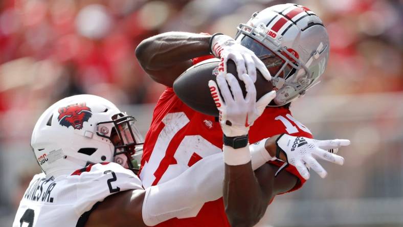 Sep 10, 2022; Columbus, Ohio, USA;  Ohio State Buckeyes wide receiver Marvin Harrison Jr. (18) makes the touchdown catch over Arkansas State Red Wolves cornerback Leon Jones (2) during the second half at Ohio Stadium. Mandatory Credit: Joseph Maiorana-USA TODAY Sports