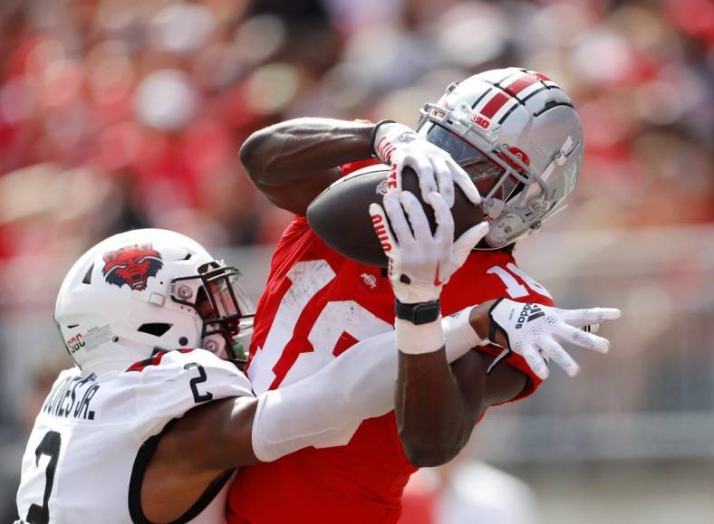 Sep 10, 2022; Columbus, Ohio, USA;  Ohio State Buckeyes wide receiver Marvin Harrison Jr. (18) makes the touchdown catch over Arkansas State Red Wolves cornerback Leon Jones (2) during the second half at Ohio Stadium. Mandatory Credit: Joseph Maiorana-USA TODAY Sports