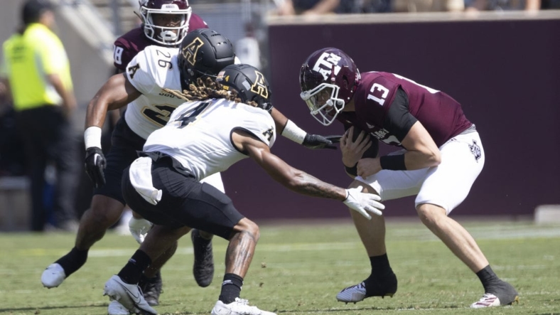 Sep 10, 2022; College Station, Texas, USA;Texas A&M Aggies quarterback Haynes King (13) is tackled by Appalachian State Mountaineers defensive back Nick Ross (4) in the second quarter at Kyle Field. Mandatory Credit: Thomas Shea-USA TODAY Sports