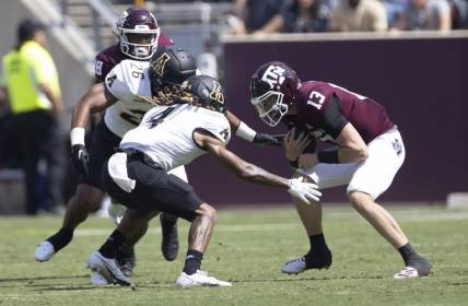 Sep 10, 2022; College Station, Texas, USA;Texas A&M Aggies quarterback Haynes King (13) is tackled by Appalachian State Mountaineers defensive back Nick Ross (4) in the second quarter at Kyle Field. Mandatory Credit: Thomas Shea-USA TODAY Sports