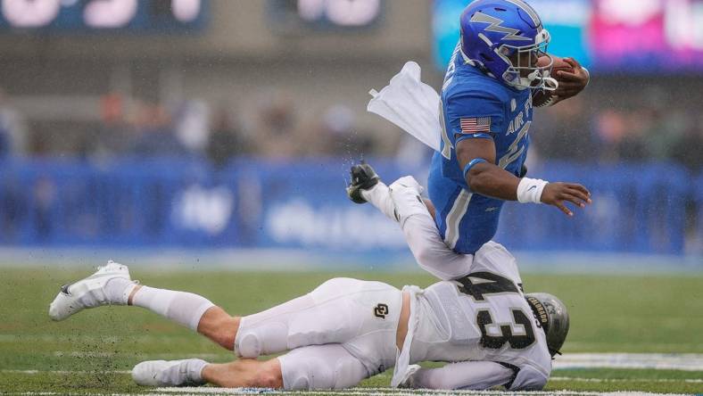 Sep 10, 2022; Colorado Springs, Colorado, USA; Air Force Falcons running back John Lee Eldridge III (24) is tackled by Colorado Buffaloes safety Trevor Woods (43) in the first quarter at Falcon Stadium. Mandatory Credit: Isaiah J. Downing-USA TODAY Sports