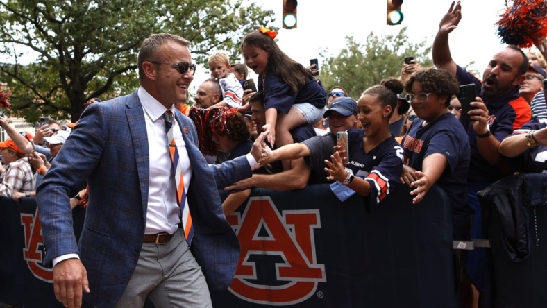 Sep 10, 2022; Auburn, Alabama, USA;  Auburn Tigers head coach Bryan Harsin greets fans during Tiger Walk with the team before the game against the San Jose State Spartans at Jordan-Hare Stadium. Mandatory Credit: John Reed-USA TODAY Sports