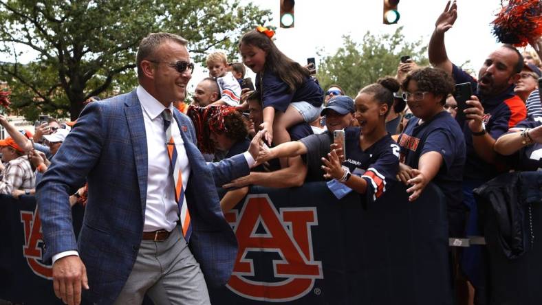 Sep 10, 2022; Auburn, Alabama, USA;  Auburn Tigers head coach Bryan Harsin greets fans during Tiger Walk with the team before the game against the San Jose State Spartans at Jordan-Hare Stadium. Mandatory Credit: John Reed-USA TODAY Sports