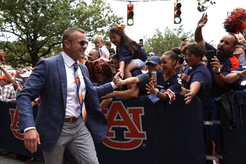 Sep 10, 2022; Auburn, Alabama, USA;  Auburn Tigers head coach Bryan Harsin greets fans during Tiger Walk with the team before the game against the San Jose State Spartans at Jordan-Hare Stadium. Mandatory Credit: John Reed-USA TODAY Sports