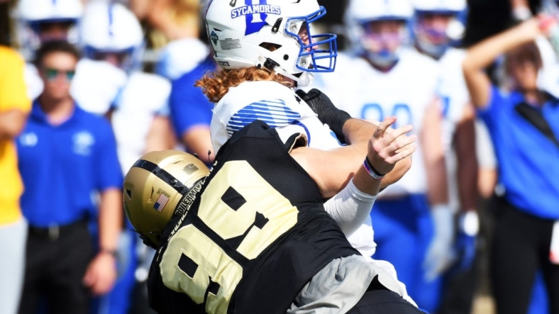 Sep 10, 2022; West Lafayette, Indiana, USA;  Indiana State Sycamores quarterback Gavin Screws (10) is sacked by Purdue Boilermakers defensive end Jack Sullivan (99) during the first quarter against the Purdue Boilermakers at Ross-Ade Stadium. Mandatory Credit: Robert Goddin-USA TODAY Sports