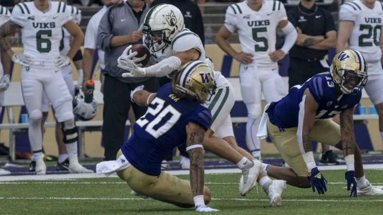 Sep 10, 2022; Seattle, Washington, USA; Portland State Vikings wide receiver Beau Kelly (13) escapes the grasp of Washington Huskies defensive back Asa Turner (20) and linebacker Kamren Fabiculanan (13) after a reception during the first half at Alaska Airlines Field at Husky Stadium. Mandatory Credit: Stephen Brashear-USA TODAY Sports