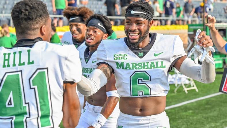 Sep 10, 2022; South Bend, Indiana, USA; Marshall Thundering Herd defensive back Micah Abraham (6) celebrates as he leaves the field after the Thundering Herd beat the Notre Dame Fighting Irish 26-21 at Notre Dame Stadium. Mandatory Credit: Matt Cashore-USA TODAY Sports