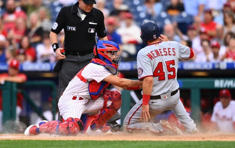 Sep 10, 2022; Philadelphia, Pennsylvania, USA; Philadelphia Phillies catcher Garrett Stubbs (21) tags out Washington Nationals outfielder Joey Meneses (45) in the first inning at Citizens Bank Park. Mandatory Credit: Kyle Ross-USA TODAY Sports
