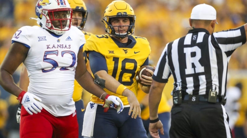 Sep 10, 2022; Morgantown, West Virginia, USA; West Virginia Mountaineers quarterback JT Daniels (18) reacts after a penalty during the second quarter against the Kansas Jayhawks at Mountaineer Field at Milan Puskar Stadium. Mandatory Credit: Ben Queen-USA TODAY Sports