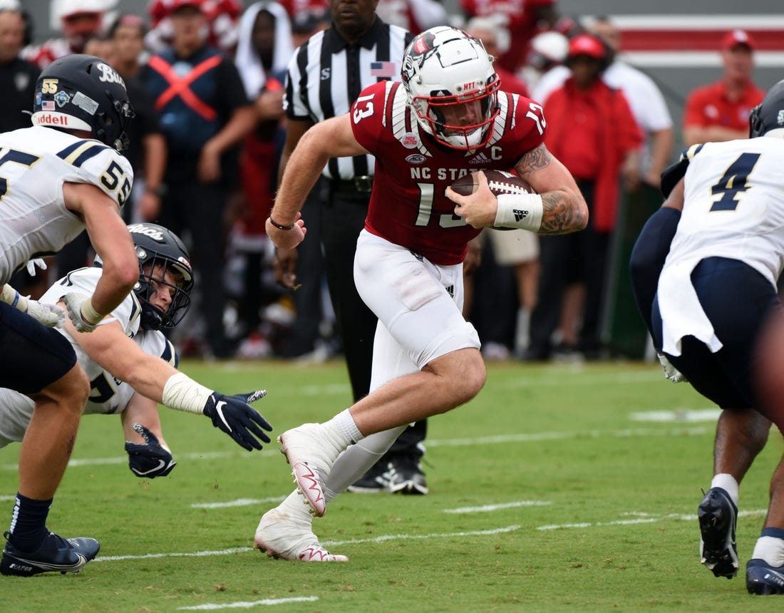 Sep 10, 2022; Raleigh, North Carolina, USA; North Carolina State Wolfpack quarterback Devin Leary (13) runs  for a touchdown during the first half against the Charleston Southern Buccaneers at Carter-Finley Stadium. Mandatory Credit: Rob Kinnan-USA TODAY Sports