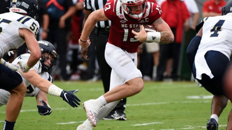 Sep 10, 2022; Raleigh, North Carolina, USA; North Carolina State Wolfpack quarterback Devin Leary (13) runs  for a touchdown during the first half against the Charleston Southern Buccaneers at Carter-Finley Stadium. Mandatory Credit: Rob Kinnan-USA TODAY Sports