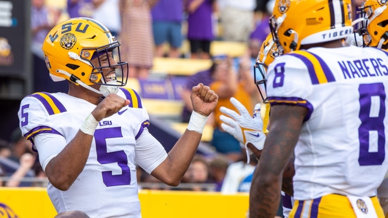 Sep 10, 2022; Baton Rouge, Louisiana, USA;  LSU Tigers quarterback Jayden Daniels (5) celebrates after scoring a touchdown against the Southern Jaguars at Tiger Stadium. Mandatory Credit: Scott Clause-USA TODAY Sports
