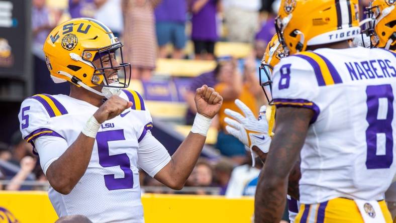 Sep 10, 2022; Baton Rouge, Louisiana, USA;  LSU Tigers quarterback Jayden Daniels (5) celebrates after scoring a touchdown against the Southern Jaguars at Tiger Stadium. Mandatory Credit: Scott Clause-USA TODAY Sports