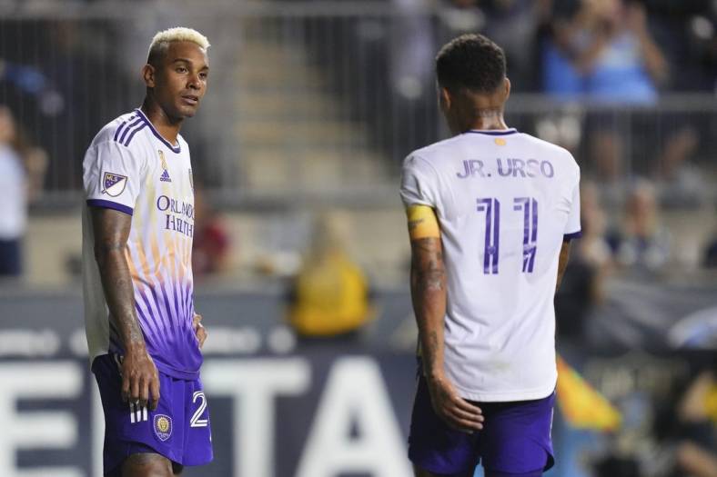 Sep 10, 2022; Chester, Pennsylvania, USA; Orlando City defender Antonio Carlos (25) and midfielder Junior Urso (11) look on after a goal by the Philadelphia Union in the second half at Subaru Park. Mandatory Credit: Mitchell Leff-USA TODAY Sports